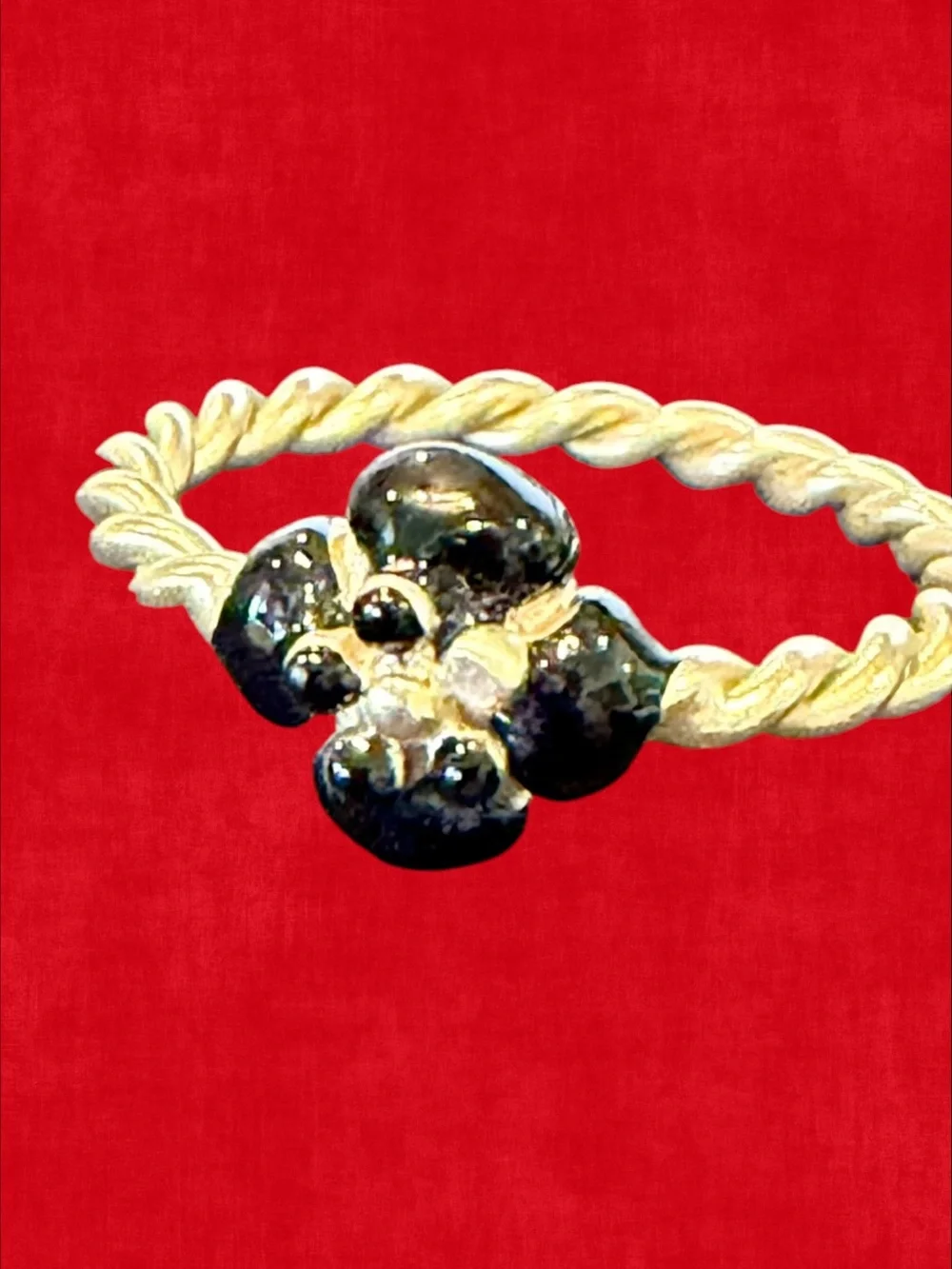 CHANEL Gold-Tone Twisted Band Ring with Black Floral Motif